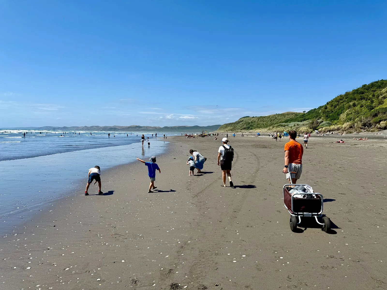 Families and kids on Ngarunui Beach, Raglan — a typical Saturday for a Waikato Hospital Locum SMO, 45 minutes from Hamilton, New Zealand